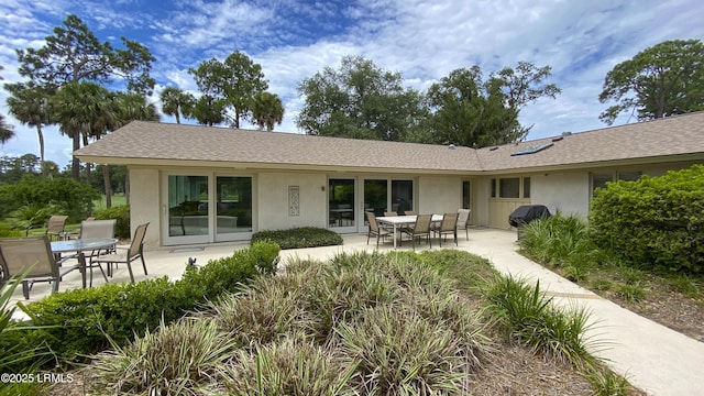 rear view of property featuring a patio