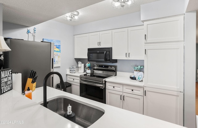 kitchen featuring sink, a textured ceiling, white cabinets, and appliances with stainless steel finishes