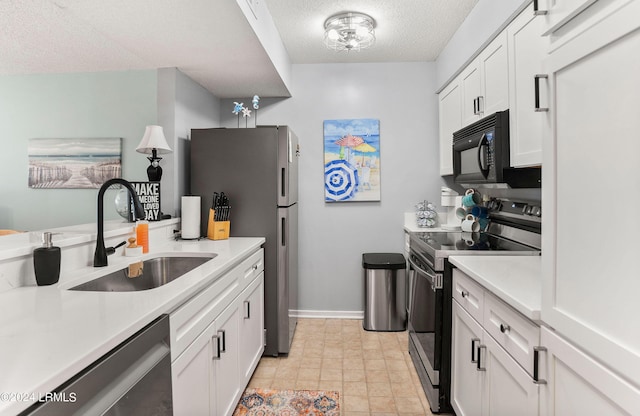 kitchen featuring white cabinetry, appliances with stainless steel finishes, sink, and a textured ceiling