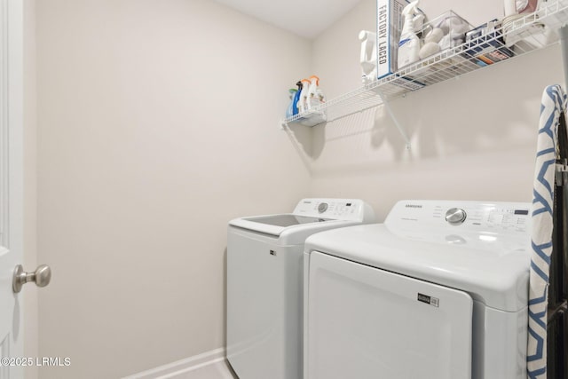 washroom featuring separate washer and dryer and baseboards