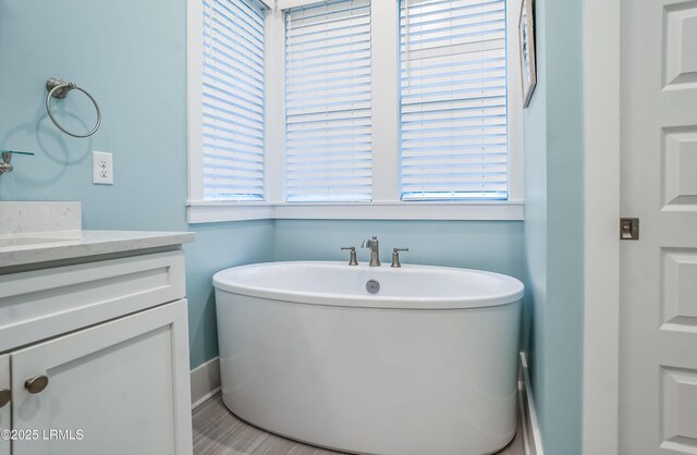 bathroom with a bathing tub and vanity