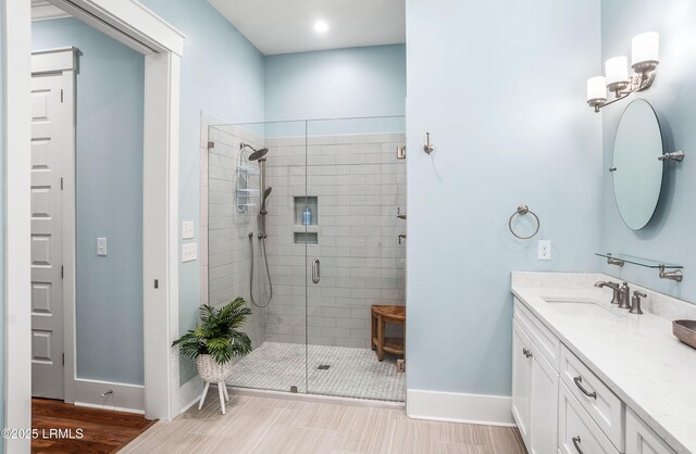 bathroom featuring an enclosed shower and vanity