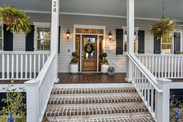 view of exterior entry featuring a porch