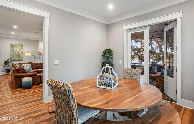 dining room with hardwood / wood-style flooring and ornamental molding