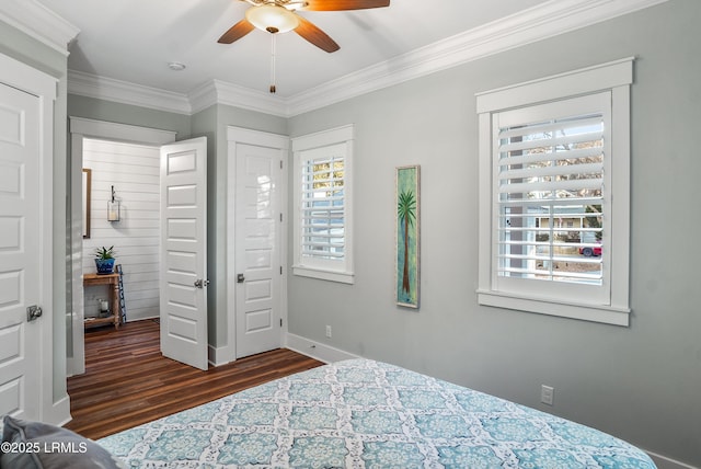 bedroom featuring dark hardwood / wood-style flooring, crown molding, and ceiling fan