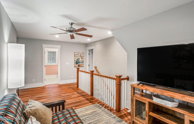 living room featuring vaulted ceiling, hardwood / wood-style floors, and ceiling fan