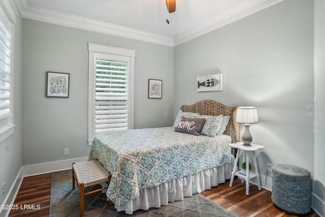 bedroom featuring hardwood / wood-style floors, ornamental molding, and ceiling fan