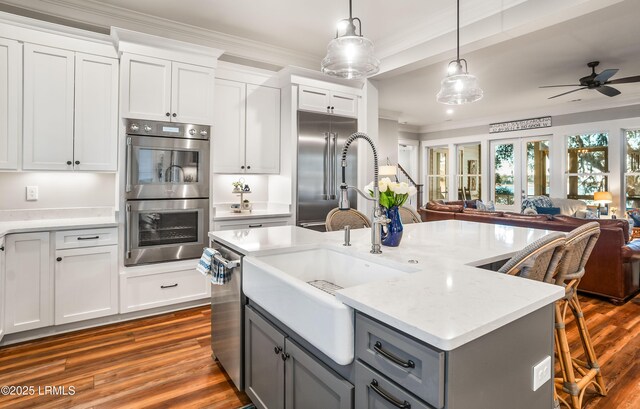 kitchen featuring stainless steel appliances, white cabinetry, gray cabinets, and pendant lighting