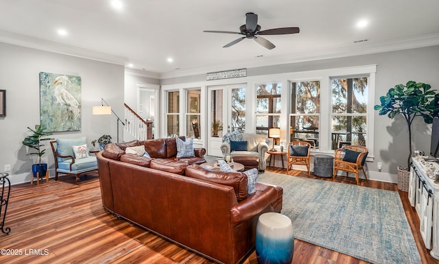 living room featuring hardwood / wood-style flooring, crown molding, and ceiling fan