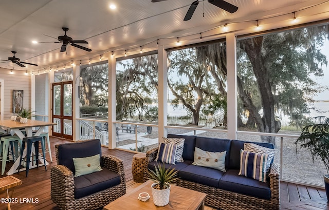 sunroom / solarium featuring ceiling fan