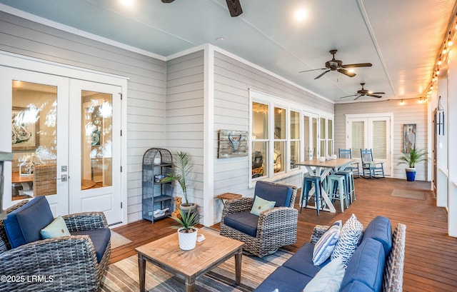 sunroom featuring french doors and ceiling fan