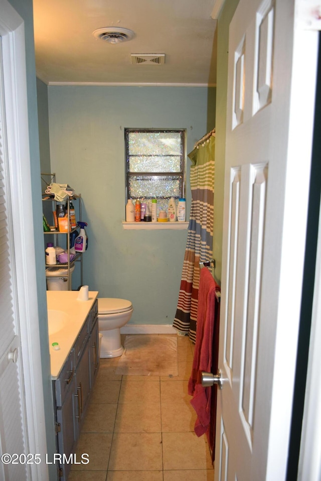 bathroom featuring vanity, tile patterned flooring, and toilet