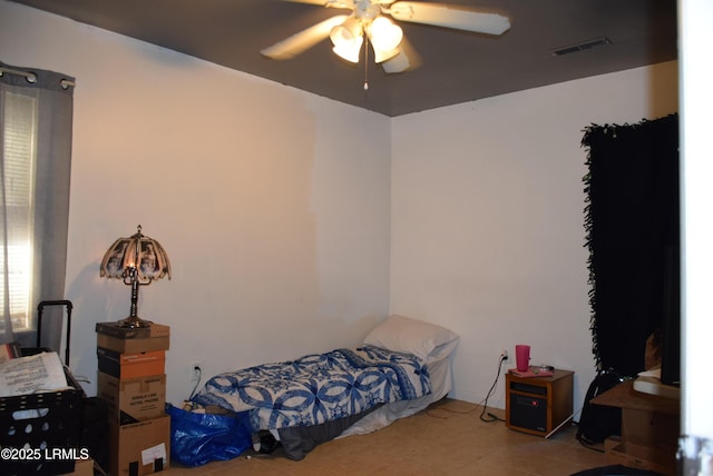 bedroom featuring ceiling fan and tile patterned floors