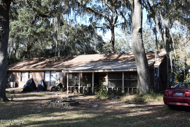 view of front of house featuring a sunroom