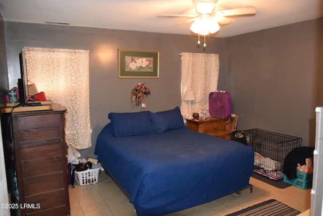 bedroom with light tile patterned floors and ceiling fan