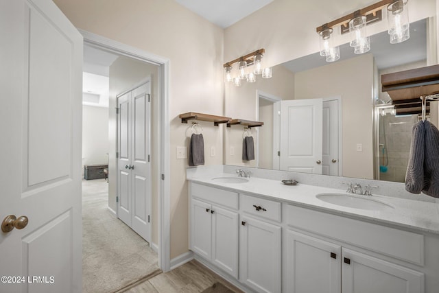 bathroom featuring vanity, hardwood / wood-style floors, and a shower with door