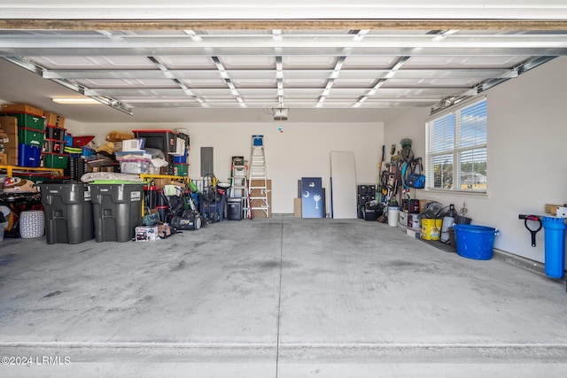 garage with a garage door opener and electric panel