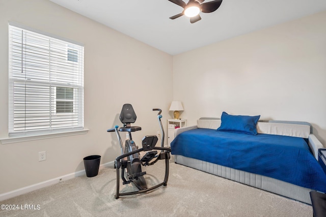 bedroom featuring multiple windows, light colored carpet, and ceiling fan