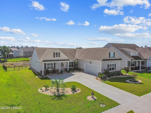 view of front of property with a garage, driveway, stone siding, fence, and a front lawn