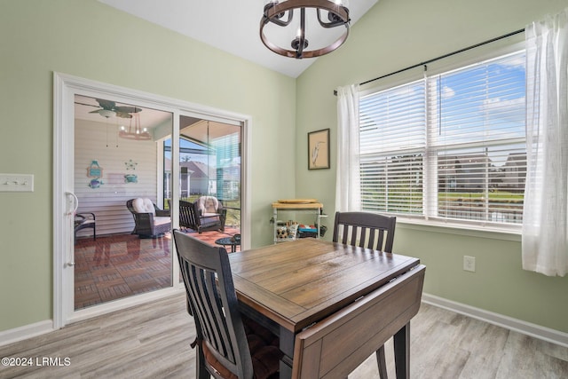 dining area featuring lofted ceiling, ceiling fan, and light wood-type flooring