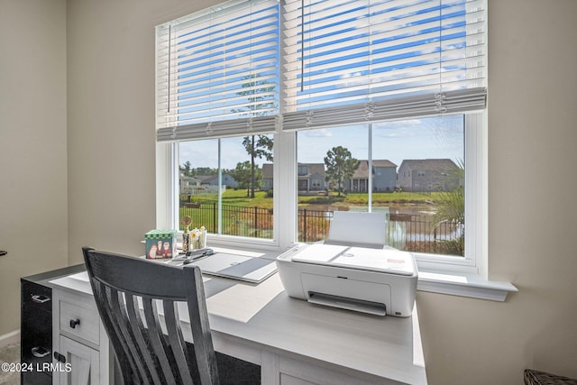 dining space with a wealth of natural light and a water view