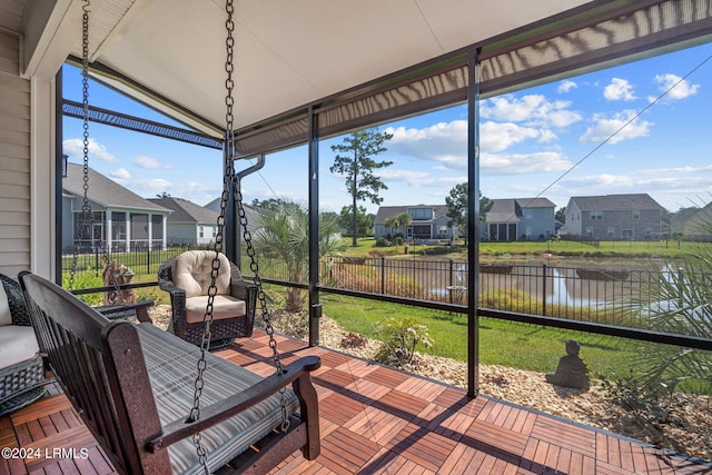 sunroom / solarium with lofted ceiling and a residential view