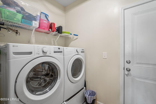 laundry area featuring washing machine and dryer, laundry area, and baseboards