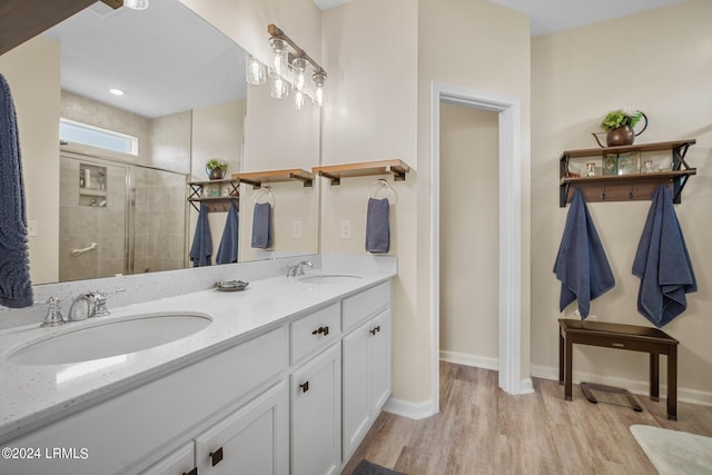 bathroom featuring vanity, hardwood / wood-style floors, and a shower with shower door