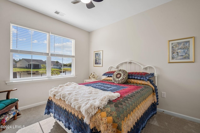 carpeted bedroom with ceiling fan, visible vents, and baseboards