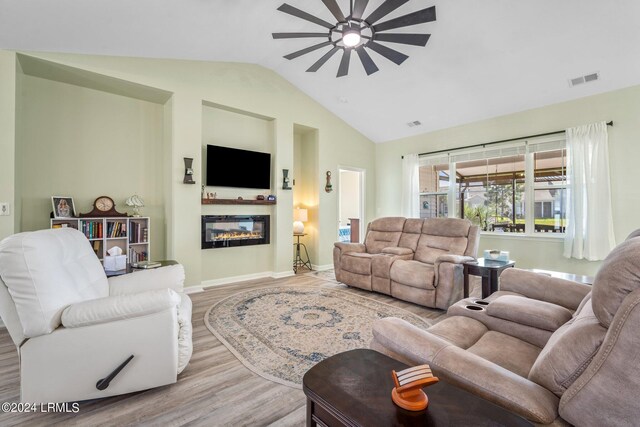 living room with vaulted ceiling, ceiling fan, and light hardwood / wood-style flooring