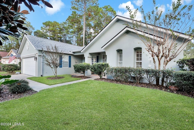 view of front of house with a garage and a front yard