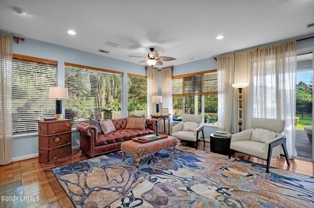 living room with a wealth of natural light and ceiling fan