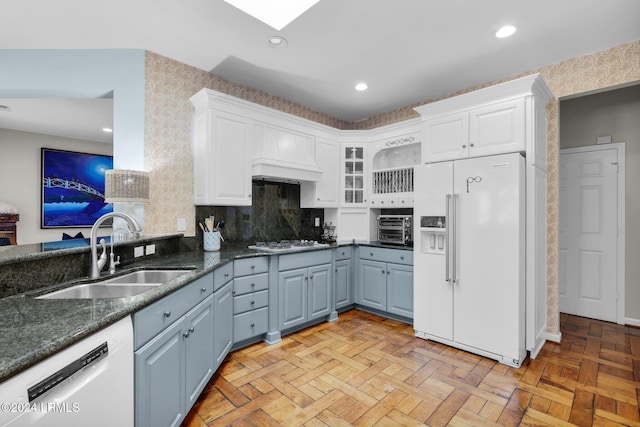 kitchen featuring white cabinetry, sink, white appliances, and light parquet floors