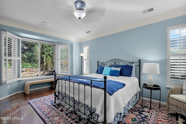 bedroom with dark wood-type flooring, ornamental molding, and ceiling fan