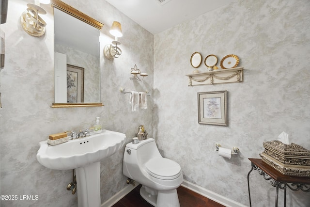 2 Lenox Ln, Hilton Head Island, SC 29926 - bathroom featuring wood finished floors, toilet, and baseboards