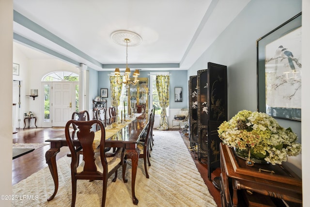 2 Lenox Ln, Hilton Head Island, SC 29926 - dining room with healthy amount of natural light, a chandelier, wood finished floors, and a raised ceiling