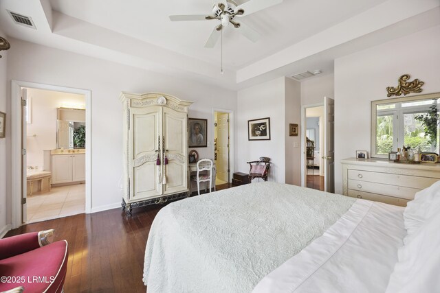2 Lenox Ln, Hilton Head Island, SC 29926 - bedroom featuring a raised ceiling, wood-type flooring, ensuite bath, baseboards, and ceiling fan