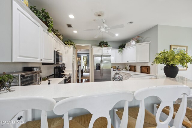 2 Lenox Ln, Hilton Head Island, SC 29926 - kitchen featuring appliances with stainless steel finishes, a peninsula, recessed lighting, a breakfast bar, and a ceiling fan