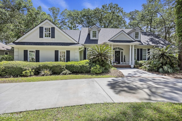 2 Lenox Ln, Hilton Head Island, SC 29926 - cape cod home with a chimney, a shingled roof, and curved driveway