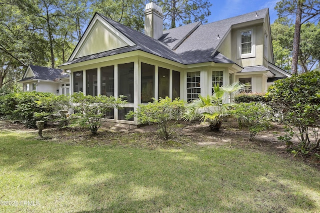 2 Lenox Ln, Hilton Head Island, SC 29926 - back of property with a sunroom, a chimney, a yard, and a shingled roof