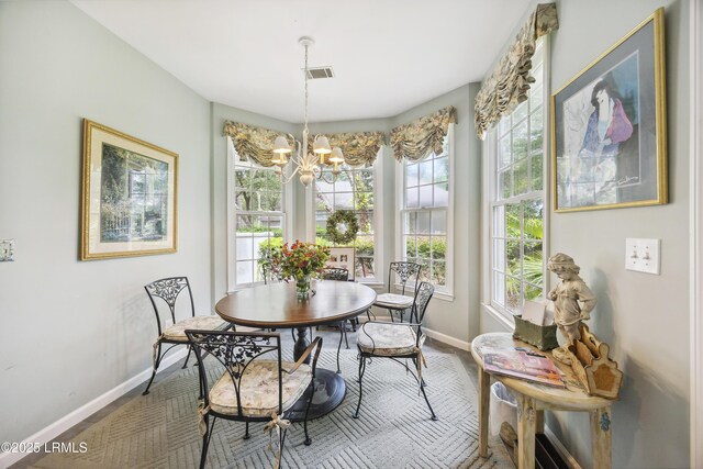 2 Lenox Ln, Hilton Head Island, SC 29926 - dining space featuring baseboards and a chandelier