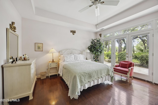 2 Lenox Ln, Hilton Head Island, SC 29926 - bedroom with access to outside, a raised ceiling, french doors, and dark wood-style flooring
