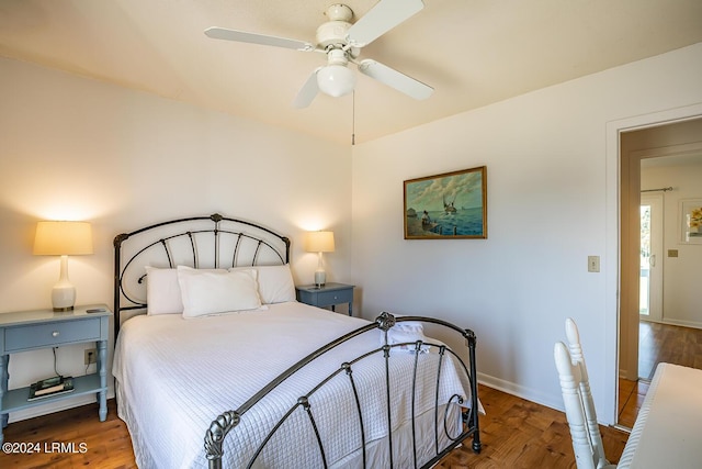 bedroom featuring dark hardwood / wood-style flooring and ceiling fan