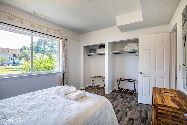 bedroom with dark hardwood / wood-style flooring, a closet, and a textured ceiling