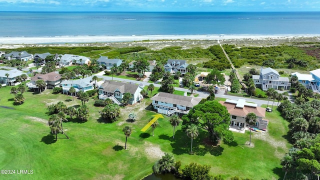 drone / aerial view with a water view and a beach view