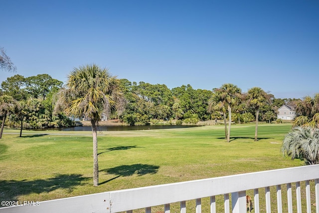 view of community featuring a lawn and a water view