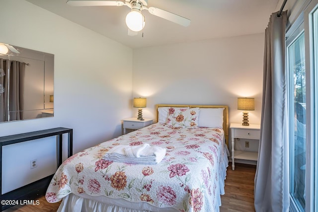 bedroom with dark hardwood / wood-style floors and ceiling fan