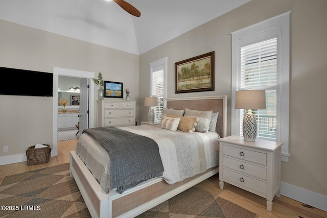 bedroom featuring ceiling fan, lofted ceiling, ensuite bath, and light hardwood / wood-style floors