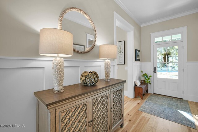 entrance foyer featuring light hardwood / wood-style flooring and ornamental molding