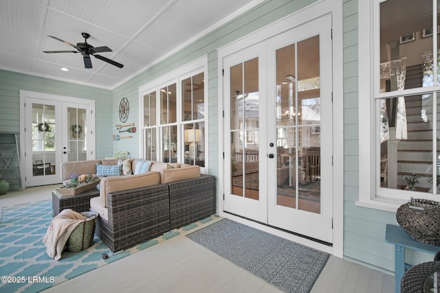 sunroom with plenty of natural light, ceiling fan, and french doors